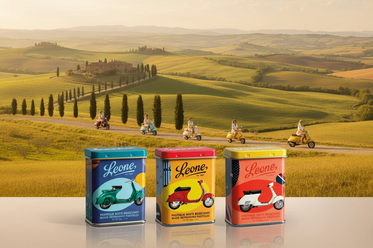 Three colorful tins with Vespa scooters on a white background